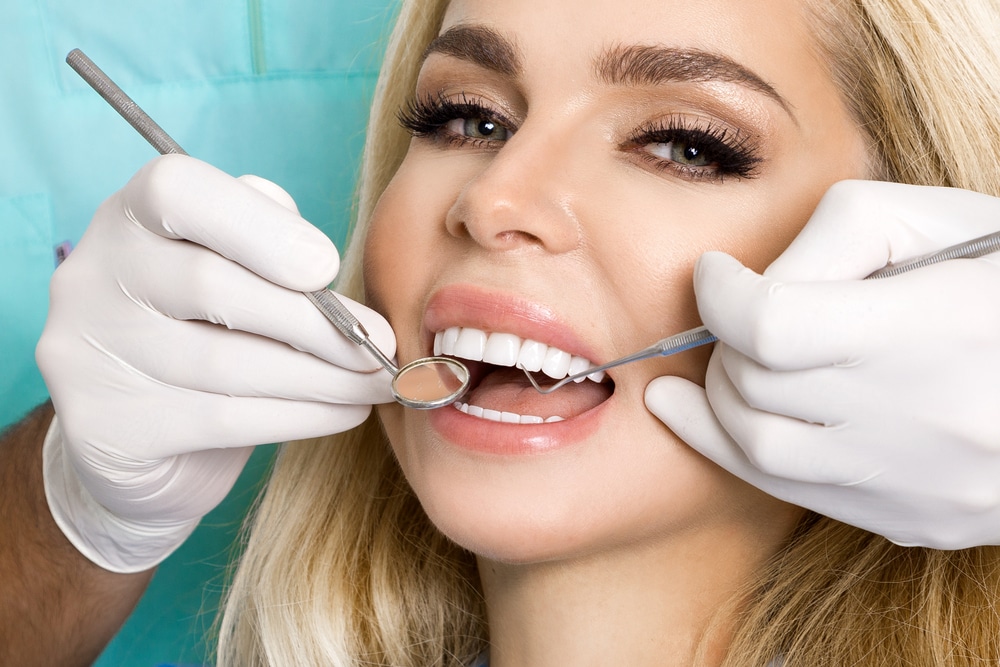 Blonde woman has a beautiful healthy smile thanks to regular dental checkups in NYC.