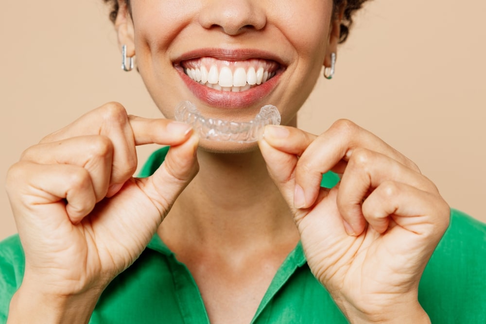 African American woman in NYC has a straight smile and bite after Invisalign.